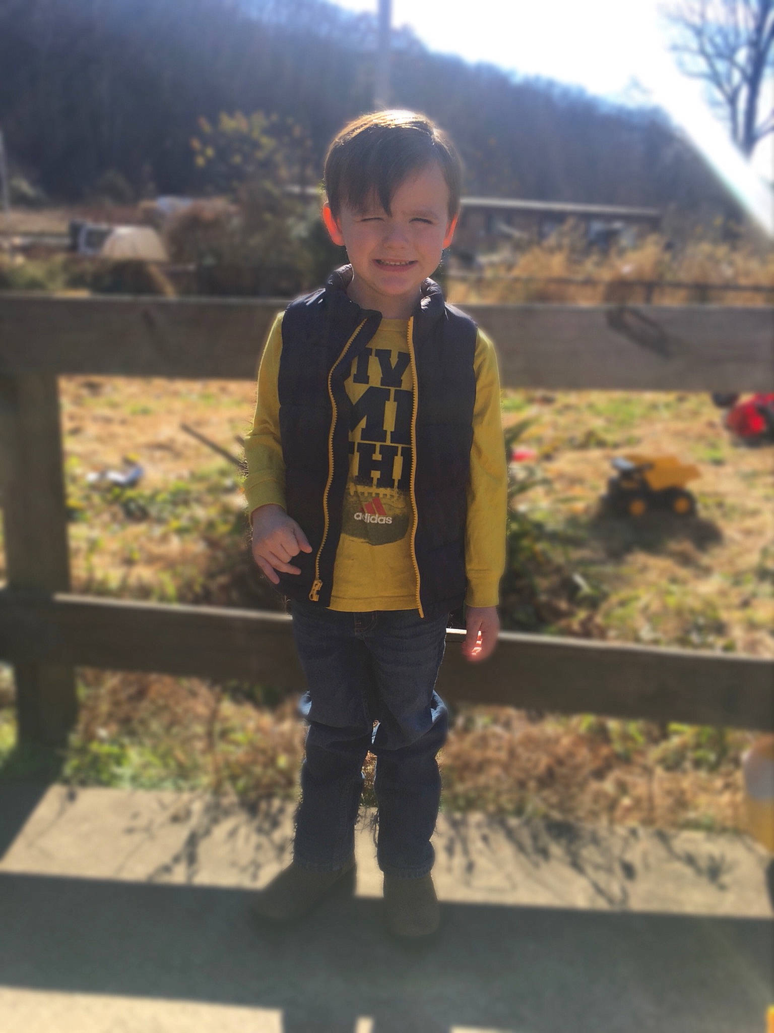 Dawson is registered to the contest to win money with this photo: boot, child, denim, fun, grass, grassland, hair, happy, head, human_body, joy, landscape, leisure, person, plant, recreation, sleeve, street_fashion, t_shirt, toddler