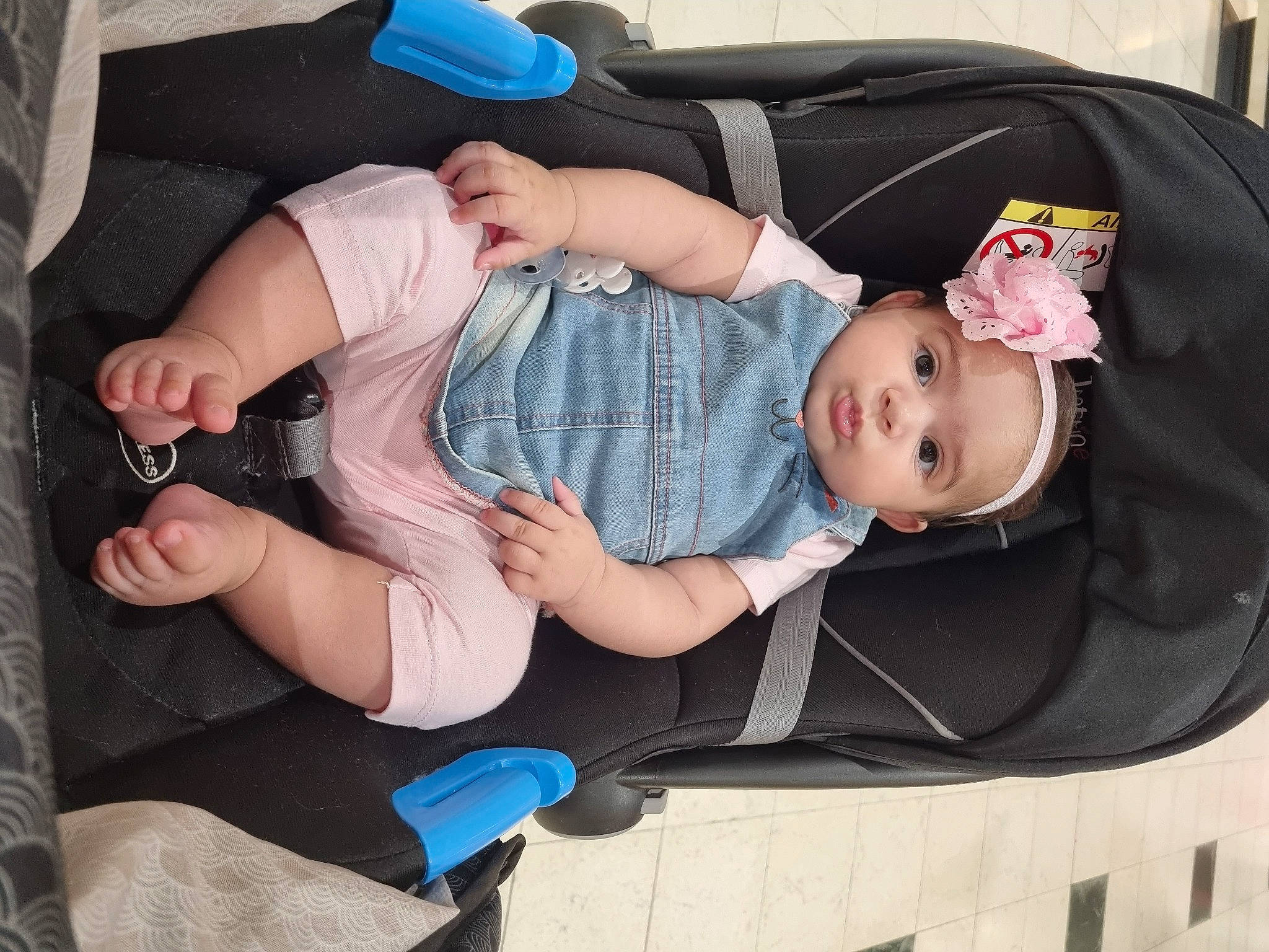 Marwa a rejoint le concours — aidez-le/la à gagner de superbes lots ! arm, auto_part, baby, baby_carriage, baby_products, baby_safety, baby_toddler_clothing, child, comfort, hand, hat, headwear, lap, leg, people, person, pink, sitting, sock, thigh