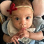 Amiyah is registered to the contest to win money with this photo: baby, infant, headband, bow, blue_dress, hands, face, eyes, curious, soft_cushion, pink, car_seat, clothing, portrait, closeup, child, cute, indoors, person, young