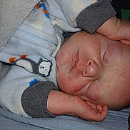 Dougie joined the competition — help win amazing prizes! baby, blanket, child, closeup, comfort, cozy, cute, cute_outfit, face, hand, indoors, infant, pajamas, peaceful, penguin, portrait, resting, sleeping, soft, warm