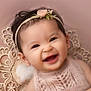 baby, smiling, infant, headband, flower, lace, portrait, closeup, happy, cute, child, earrings, soft_background, pink, adorable, young_child, fashion, beauty, baby_girl, studio