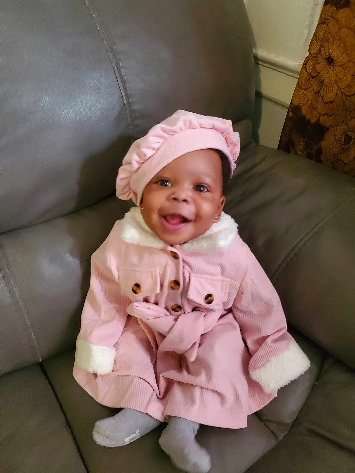 Zahara joined the competition — help win amazing prizes! baby, bonnet, cap, clothing, coat, couch, cushion, face, furniture, happy, hat, head, homedecor, hosiery, jacket, person, photography, portrait, sitting, sock