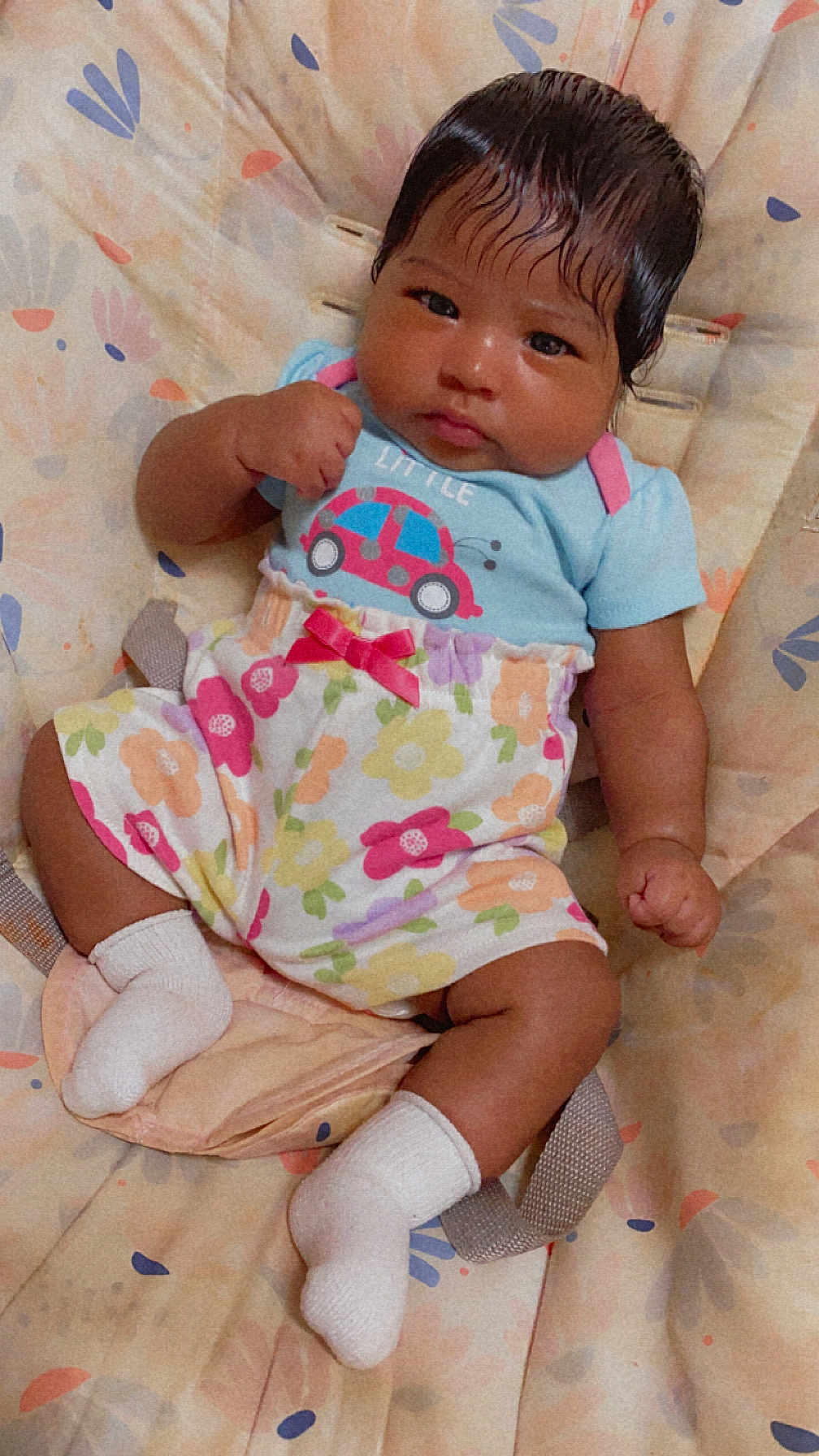 Karliynn is registered to the contest to win money with this photo: baby, child, infant, cute, sitting, clothing, socks, hair, face, fist, floral, pattern, seat, cushion, colorful, outfit, indoor, portrait, young, person