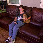 Alfa a rejoint le concours — aidez-le/la à gagner de superbes lots ! girl, dog, couch, leather, indoor, plant, window, phone, sneakers, tiled_floor, casual_clothing, brown, purple, relaxed, pet, home, portrait, sitting, young, animal