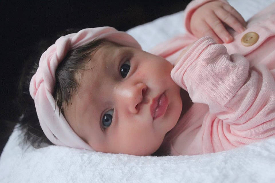 Everly is registered to the contest to win money with this photo: arm, cheek, chin, comfort, ear, eyebrow, eyelash, finger, gesture, hair, hand, happy, headgear, headwear, iris, lip, mouth, neck, nose, person