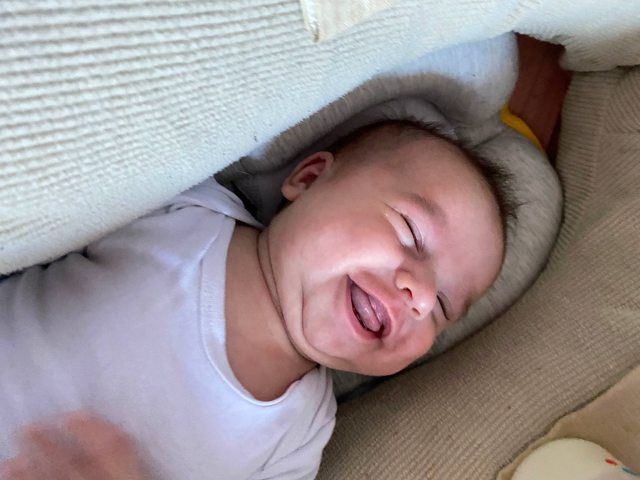 Inaya participe au concours pour gagner de l'argent avec cette photo : baby, bed, cheek, child, chin, comfort, eye, eyebrow, finger, gesture, happy, headgear, lip, mouth, nose, person, skin, sleeve, smile, textile