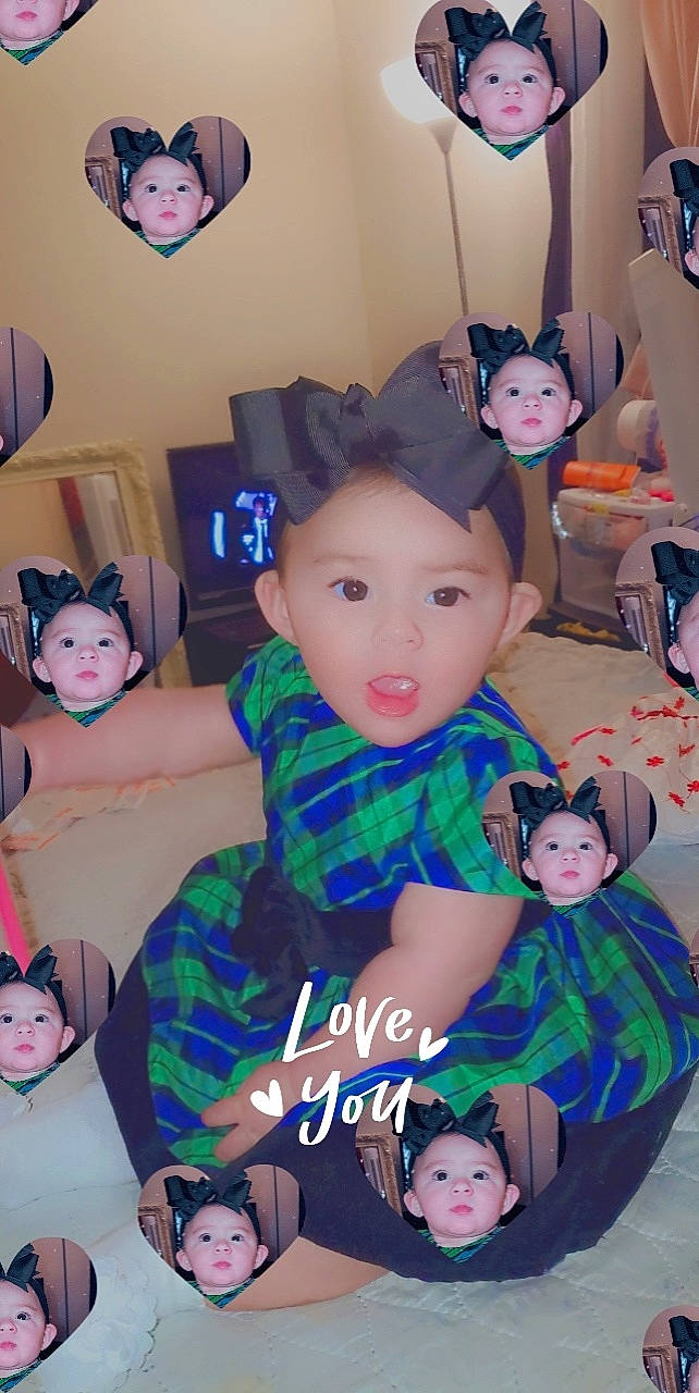 Marissa is registered to the contest to win money with this photo: baby, baby_toddler_clothing, black, blue, child, event, fun, happy, hat, lap, pattern, person, photograph, pink, product, purple, snapshot, textile, toddler, toy