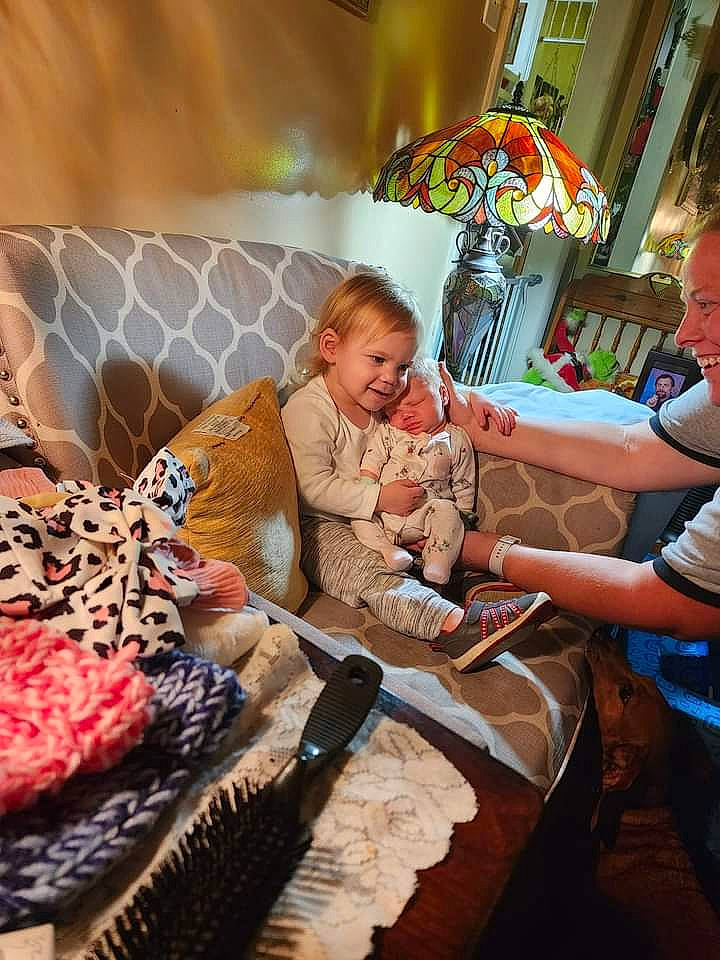 Jasmine is registered to the contest to win money with this photo: baby, chair, child, city, cuisine, dish, event, fur, joy, leisure, linens, pattern, peach, person, pillow, recreation, room, sitting, sweetness, t_shirt