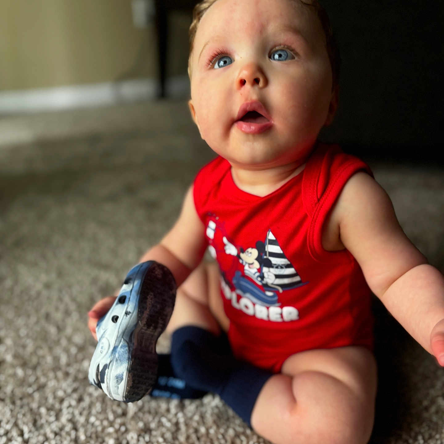Jaxon is registered to the contest to win money with this photo: baby, bodypart, clothing, couch, face, finger, footwear, furniture, hand, head, hosiery, person, photography, portrait, runningshoe, shoe, sitting, sneaker, sock, t_shirt
