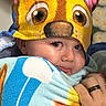 Blaze is registered to the contest to win money with this photo: blanket, cartoon, child, closeup, colorful, cute, eyes, face, hand, happy, hat, indoor, pattern, portrait, ring, snug, soft, toddler, towel, warm