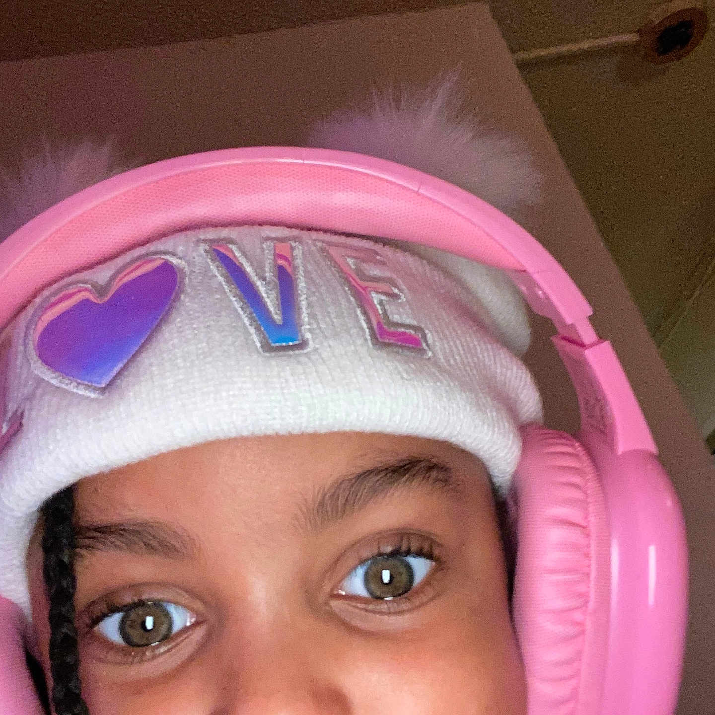 Janyla joined the competition — help win amazing prizes! braid, child, close_up, clothing, cozy, cute, expression, face, hat, headphones, headwear, indoor, love, pink, pom_poms, portrait, selfie, warm_lighting, white, young