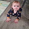 baby, child, crawling, floor, wooden_floor, onesie, animal_print, indoor, home, furniture, carpet, curious, face, hands, head, person, infant, expression, eyes, clothing