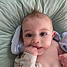 Elio a rejoint le concours — aidez-le/la à gagner de superbes lots ! baby, infant, child, face, hand, mohawk_hairstyle, towel, cushion, blanket, skin, cute, lying_down, indoors, expression, chewing, clothing, soft_texture, portrait, young, curious