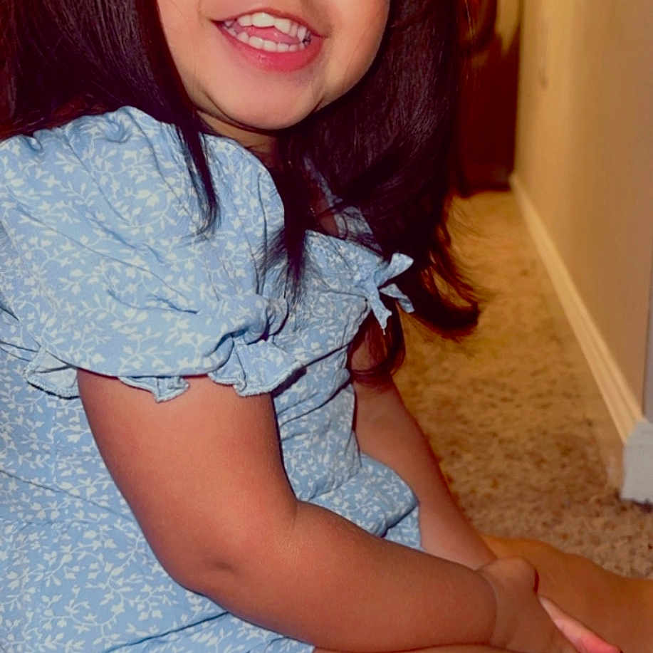 Andrea joined the competition — help win amazing prizes! blouse, bodypart, child, clothing, dress, face, female, finger, girl, hand, happy, hardwood, head, mouth, person, photography, portrait, sitting, smile, teeth