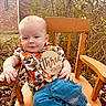 Carson joined the competition — help win amazing prizes! baby, child, wooden_chair, outdoor, nature, brick_building, shirt, jeans, sign, three_months, cute, infant, sitting, greenery, leaves, wood, portrait, casual_clothing, smiling, relaxed