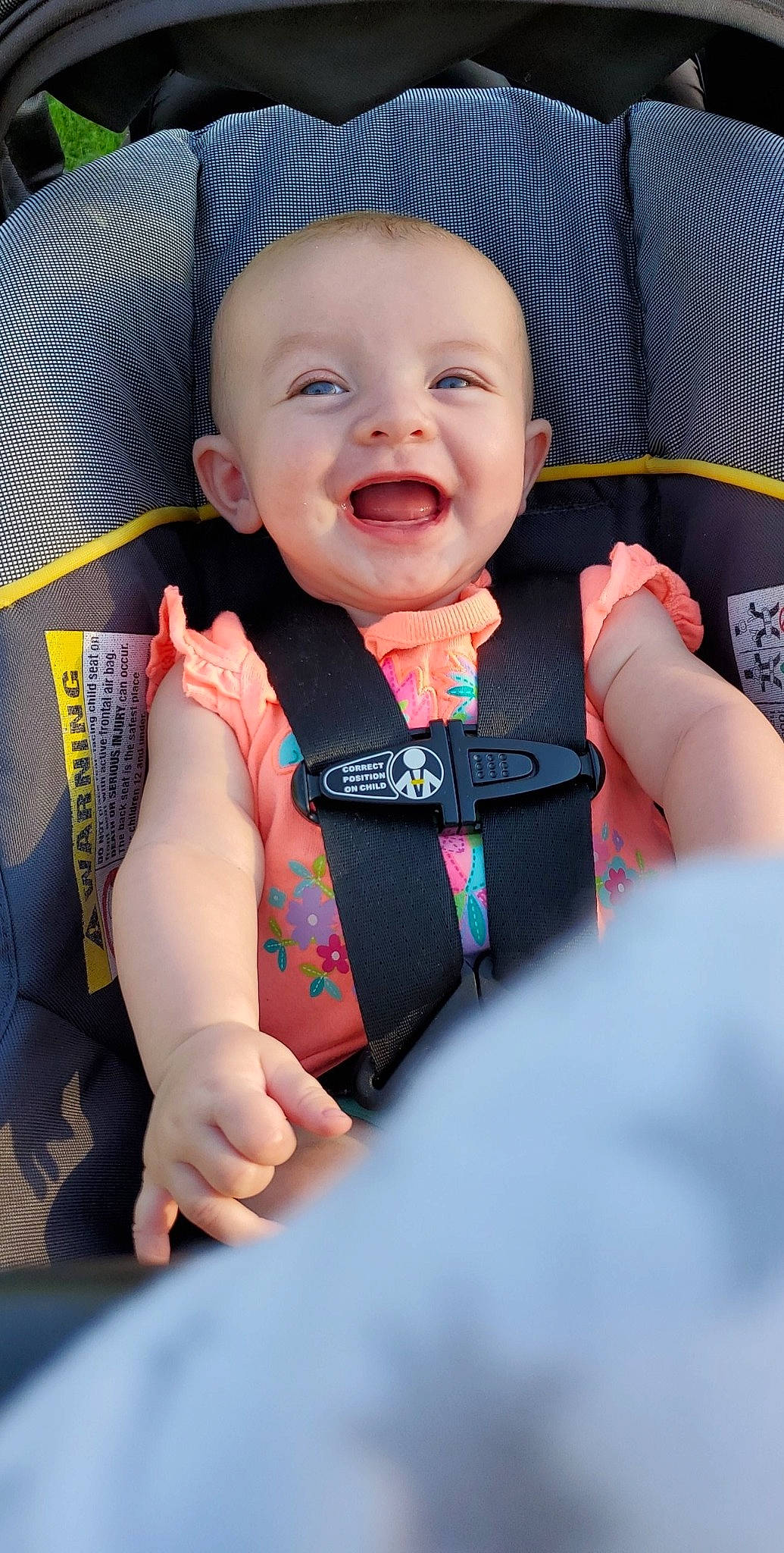 Emrie is registered to the contest to win money with this photo: baby, baby_in_car_seat, car_seat, cheek, child, facial_expression, finger, hand, laugh, nail, person, product, skin, smile, toddler