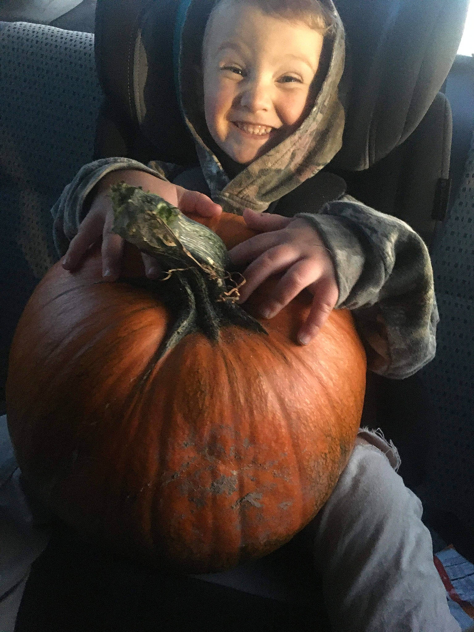 Wesley is registered to the contest to win money with this photo: arm, calabaza, child, cucurbita, food, fruit, gourd, hand, joy, local_food, person, plant, produce, pumpkin, sitting, smile, squash, vegetable, vegetarian_food, winter_squash