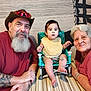 baby, child, man, woman, elderly, beard, hat, glasses, tattoo, smile, chair, table, bib, indoor, family, portrait, people, casual_clothing, happy, home