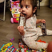 Arabella joined the competition — help win amazing prizes! toddler, child, chocolate, hersheys, candy, floor, pajamas, toy, stroller, indoor, playtime, snack, sweet, colorful, messy, hand, face, sitting, curious, young_child