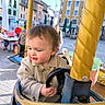 Elijah a rejoint le concours — aidez-le/la à gagner de superbes lots ! amusement_ride, building, carousel, casual_clothing, child, colorful, curly_hair, daylight, fun, happy, outdoor, people, person, playful, steering_wheel, street, sunlight, toddler, toy_car, urban