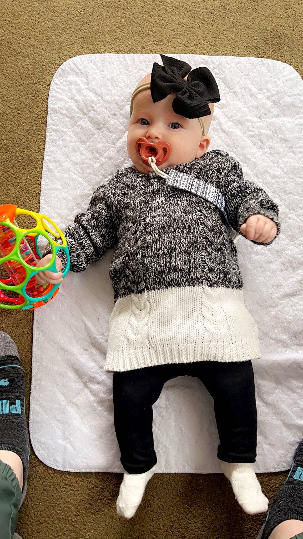 Ariya is registered to the contest to win money with this photo: arm, baby_toddler_clothing, cap, child, cool, costume_hat, doll, fashion, hat, headgear, knee, pattern, person, pink, shoe, sleeve, smile, sock, textile, thigh