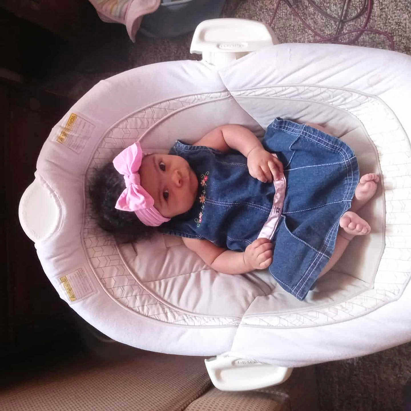 Lataeigh joined the competition — help win amazing prizes! baby, baby_rocker, carpet, child, comfortable, cozy, curly_hair, cute, denim_dress, furniture, headband, indoor, infant, looking_at_camera, pink, portrait, relaxing, seated, small_feet, soft_lighting