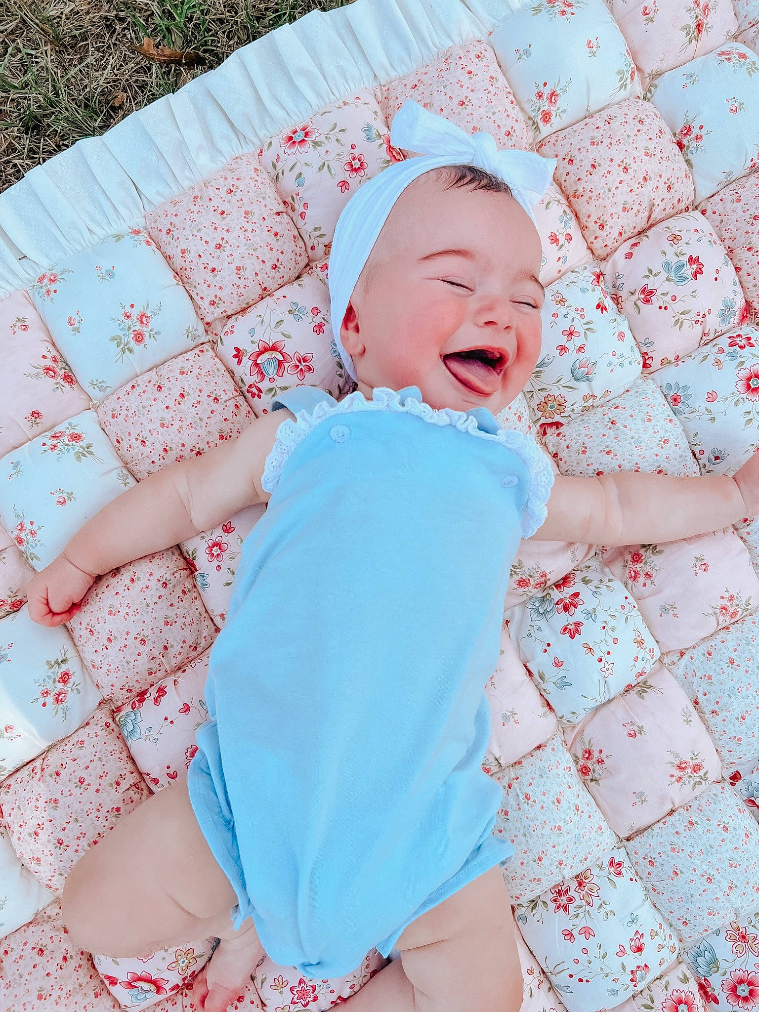 Holland joined the competition — help win amazing prizes! baby, baby_laughing, baby_toddler_clothing, child, comfort, face, finger, fun, grass, happy, linens, magenta, pattern, person, pink, sitting, skin, sleeve, smile, textile