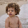 bare_chest, beach, child, curly_hair, daytime, expression, nature, ocean, outdoor, play, portrait, sand, sitting, skin, summer, toddler, vacation, water, waves, young_child