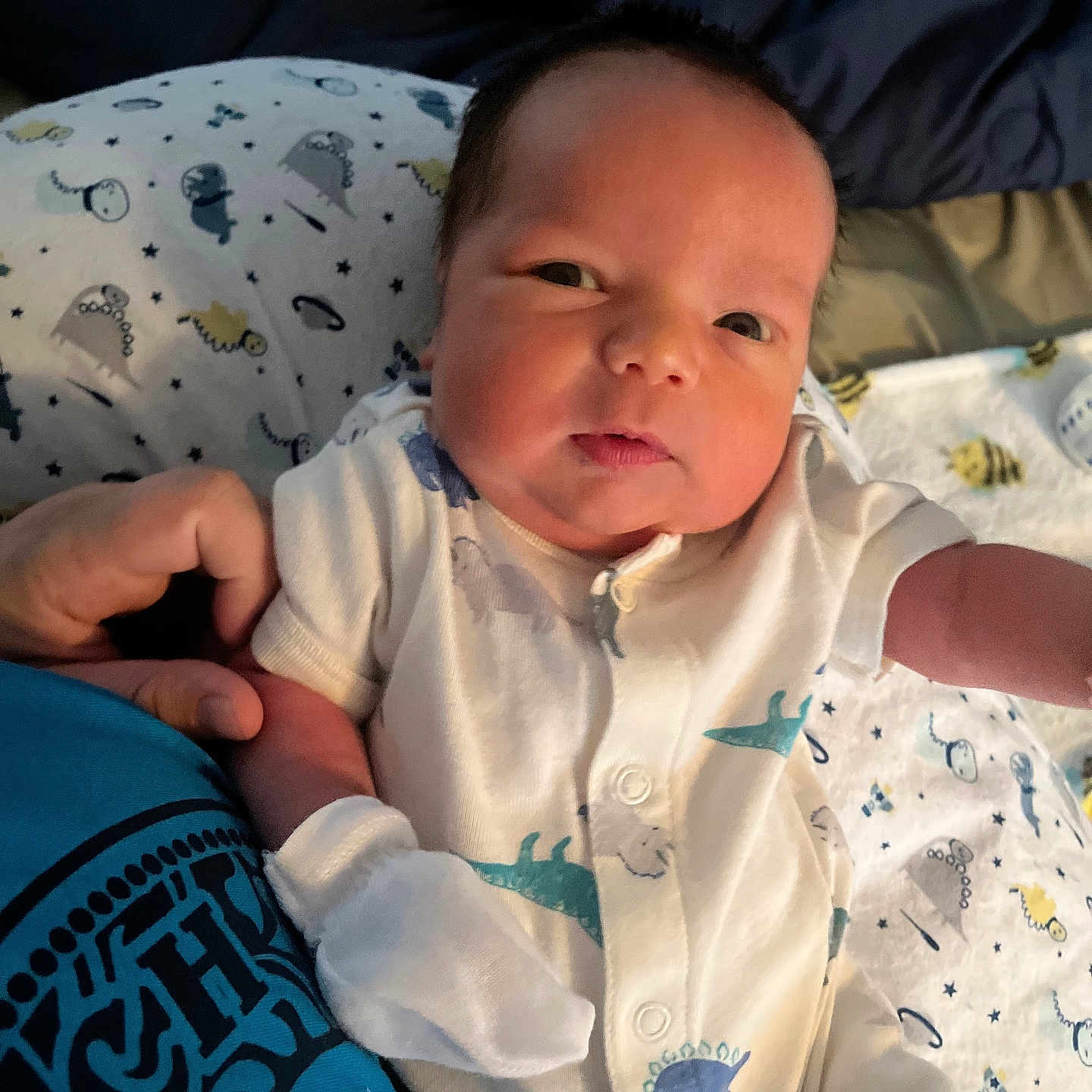 Grayson is registered to the contest to win money with this photo: baby, bed, bedroom, blanket, bodypart, cushion, face, finger, furniture, hand, head, homedecor, indoors, newborn, person, photography, portrait, quilt, room, skin