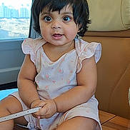 Enayah joined the competition — help win amazing prizes! baby, toddler, child, portrait, big_eyes, smiling, short_hair, pink_dress, sitting, leather_seat, train_window, wooden_table, interior, cute, indoor, skin, hand, legs, accessory, happy