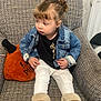 Gracie-Maè joined the competition — help win amazing prizes! toddler, child, denim_jacket, white_pants, brown_boots, armchair, plush_pillow, pumpkin_pillow, indoor, cozy, cute, seated, casual_clothing, warm, expression, hair_bun, texture, neutral_background, comfortable, portrait