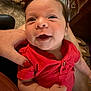 Alexander is registered to the contest to win money with this photo: baby, infant, smile, red_shirt, person, hand, furniture, carpet, indoor, cute, happy, portrait, child, skin, human, sitting, closeup, holding, face, expression