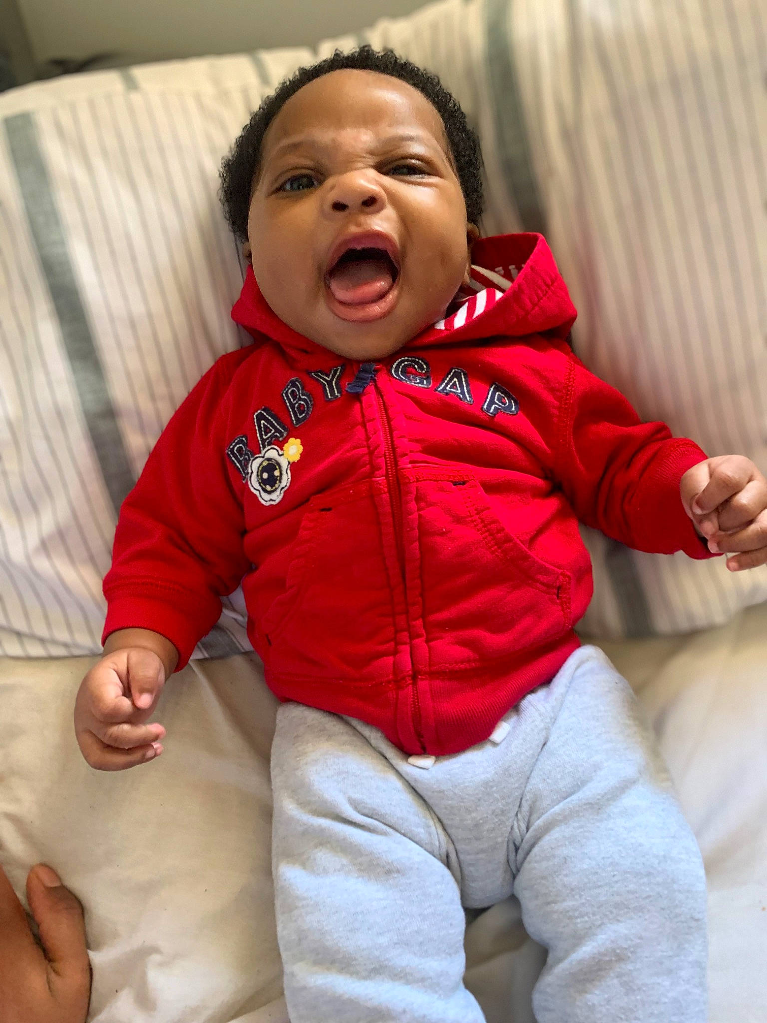 Tristan is registered to the contest to win money with this photo: baby, baby_toddler_clothing, cheek, child, comfort, eye, facial_expression, finger, flash_photography, fun, gesture, happy, head, jacket, nose, people, person, red, skin, sleeve
