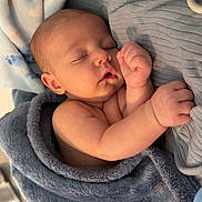 Koleton is registered to the contest to win money with this photo: baby, infant, newborn, sleeping, blanket, swaddle, blue_blanket, cozy, portrait, face, hand, arm, crib, nursery, soft_texture, peaceful, closeup, eyelashes, skin, resting