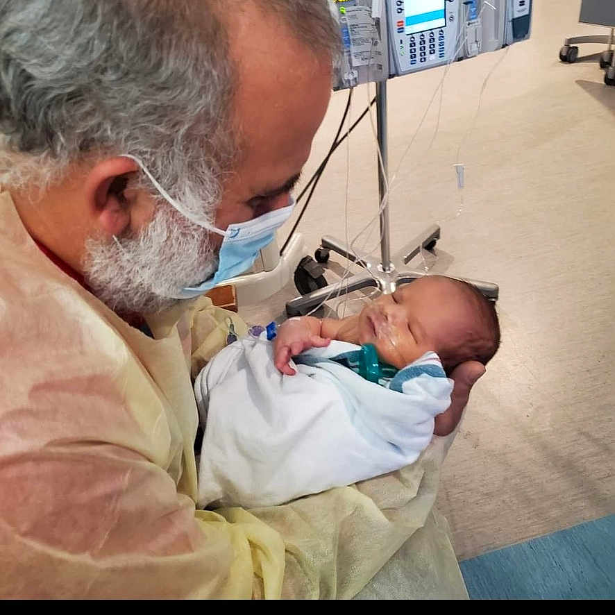 Sullivan Hoy is registered to the contest to win money with this photo: accessories, architecture, baby, bodypart, building, clinic, doctor, face, finger, glasses, hand, head, hospital, indoors, medicalprocedure, newborn, operatingtheatre, person, photography, portrait