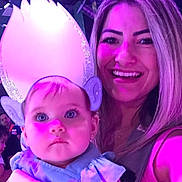 Mia participe au concours pour gagner de l'argent avec cette photo : baby, child, woman, face, costume, ears, headpiece, blue_clothing, portrait, smile, purple_light, indoor, people, parent, childhood, person, happy, cute, event, celebration