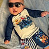 baby, child, sunglasses, blue_blanket, paw_patrol, clothing, shorts, shirt, lying_down, indoors, cute, infant, smiling, head, face, person, baby_clothes, relaxing, toy_theme, playful