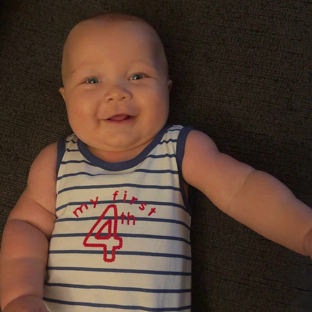 Kyaire is registered to the contest to win money with this photo: baby, child, smiling, striped_shirt, sleeveless, textile, couch, arm, face, happy, infant, cute, portrait, indoor, young, human, skin, person, clothing, fabric