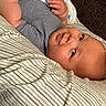 Kyaire joined the competition — help win amazing prizes! baby, child, striped_clothing, pillow, bed, infant, face, smile, skin, hand, lying_down, comfortable, cute, eyes, head, young_child, indoors, portrait, person, cozy