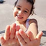 Maddy participe au concours pour gagner de l'argent avec cette photo : child, smiling, hands, outdoor, sunlight, parking_lot, cars, trees, white_tank_top, joyful, happy, playful, young_child, face, person, summer, cute, curly_hair, daytime, casual_clothing