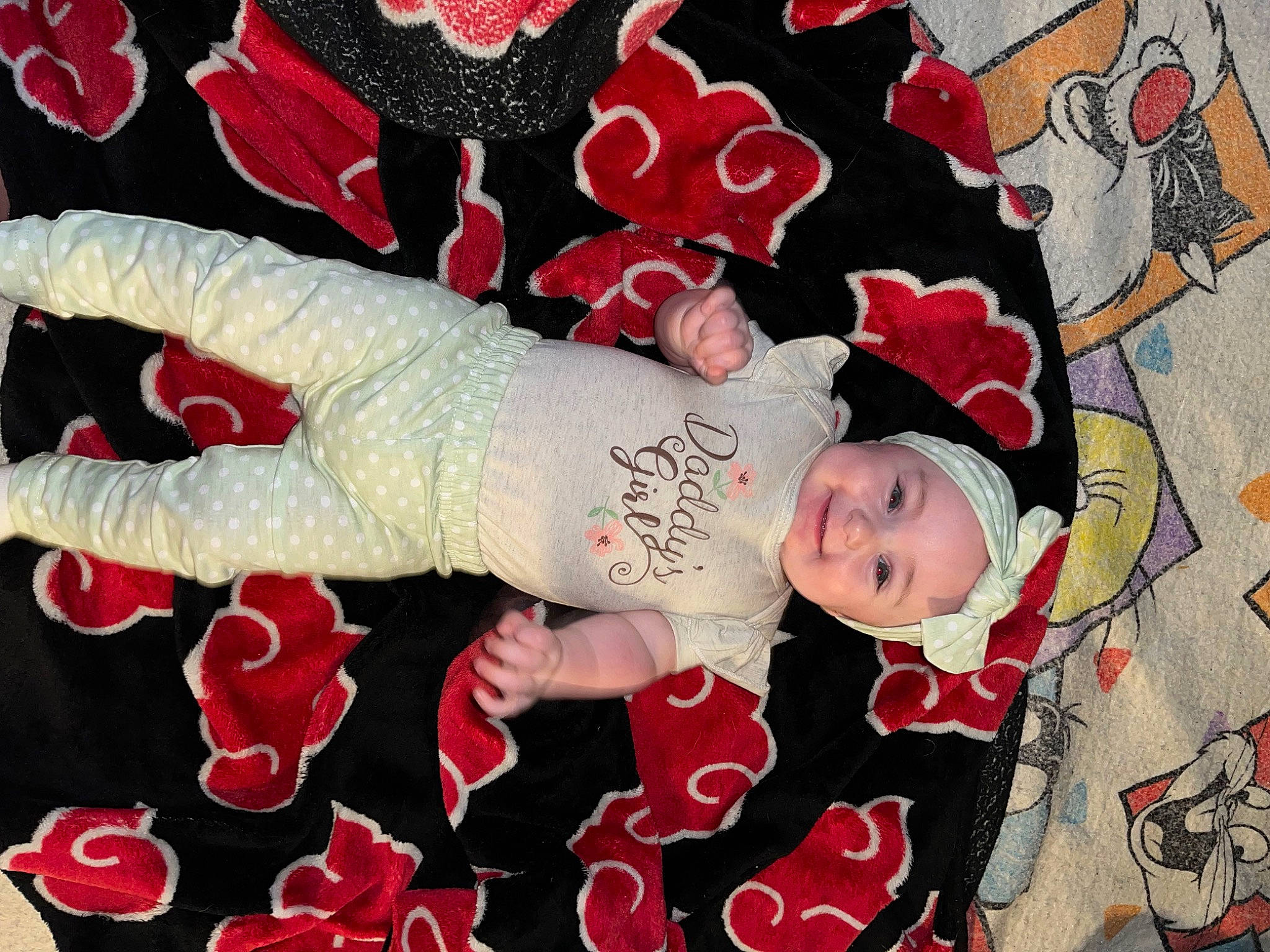 Annabelle is registered to the contest to win money with this photo: baby, baby_toddler_clothing, carmine, child, creative_arts, fashion_accessory, flesh, flooring, font, happy, headwear, joy, linens, pattern, peach, person, pink, red, room, sleeve