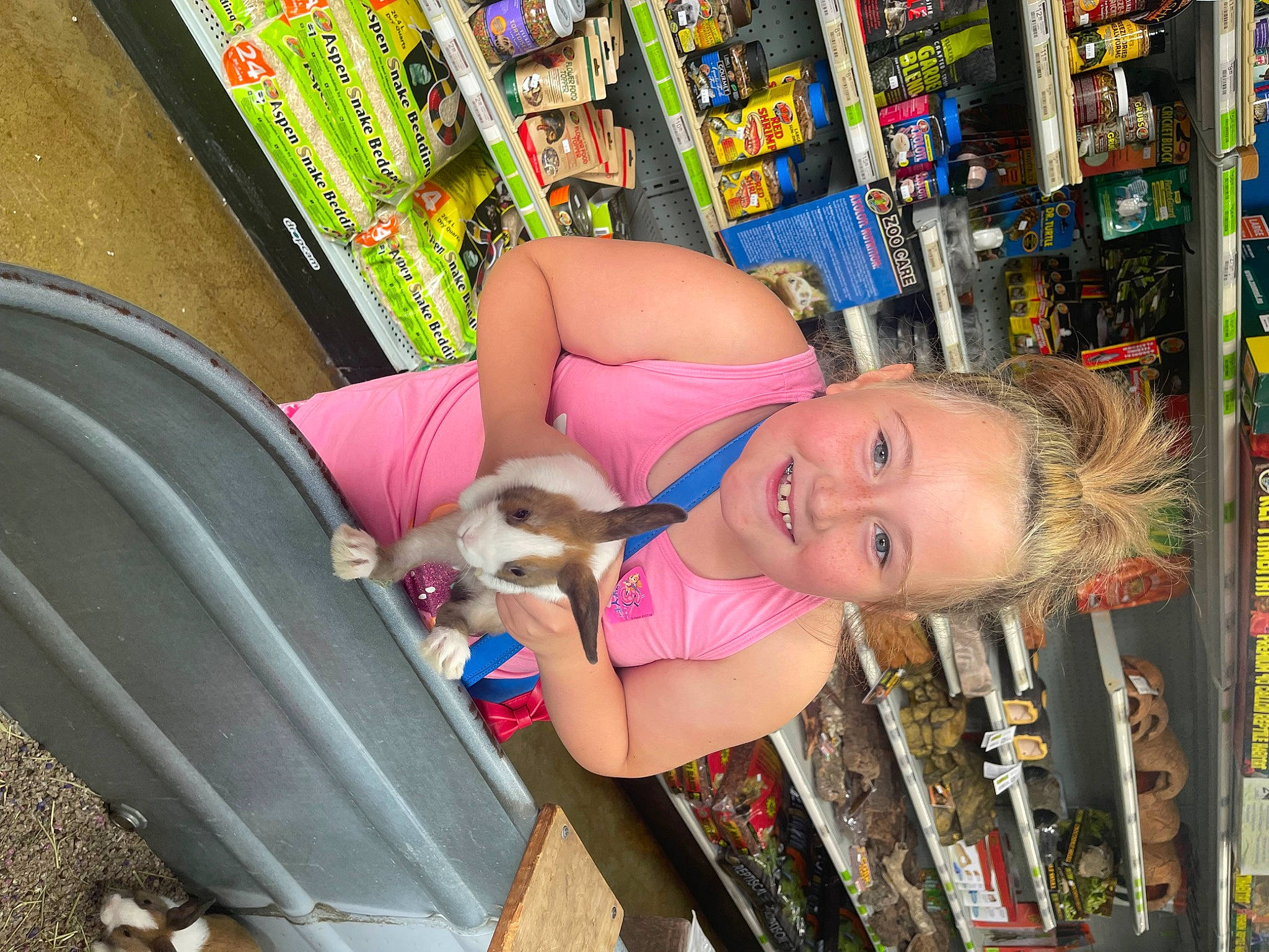 Jacklynn is registered to the contest to win money with this photo: carnivore, companion_dog, convenience_store, customer, dog, fawn, fun, happy, human_leg, joy, leisure, person, pet_supply, product, publication, retail, shelf, shelving, shopping, smile