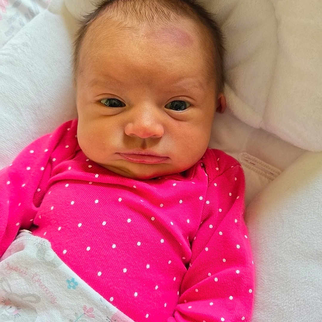 Everly Rose is registered to the contest to win money with this photo: baby, blanket, child, cushion, cute, face, hand, head, indoor, infant, newborn, person, pink_clothing, polka_dots, portrait, resting, sleepy, soft, wrapped, young