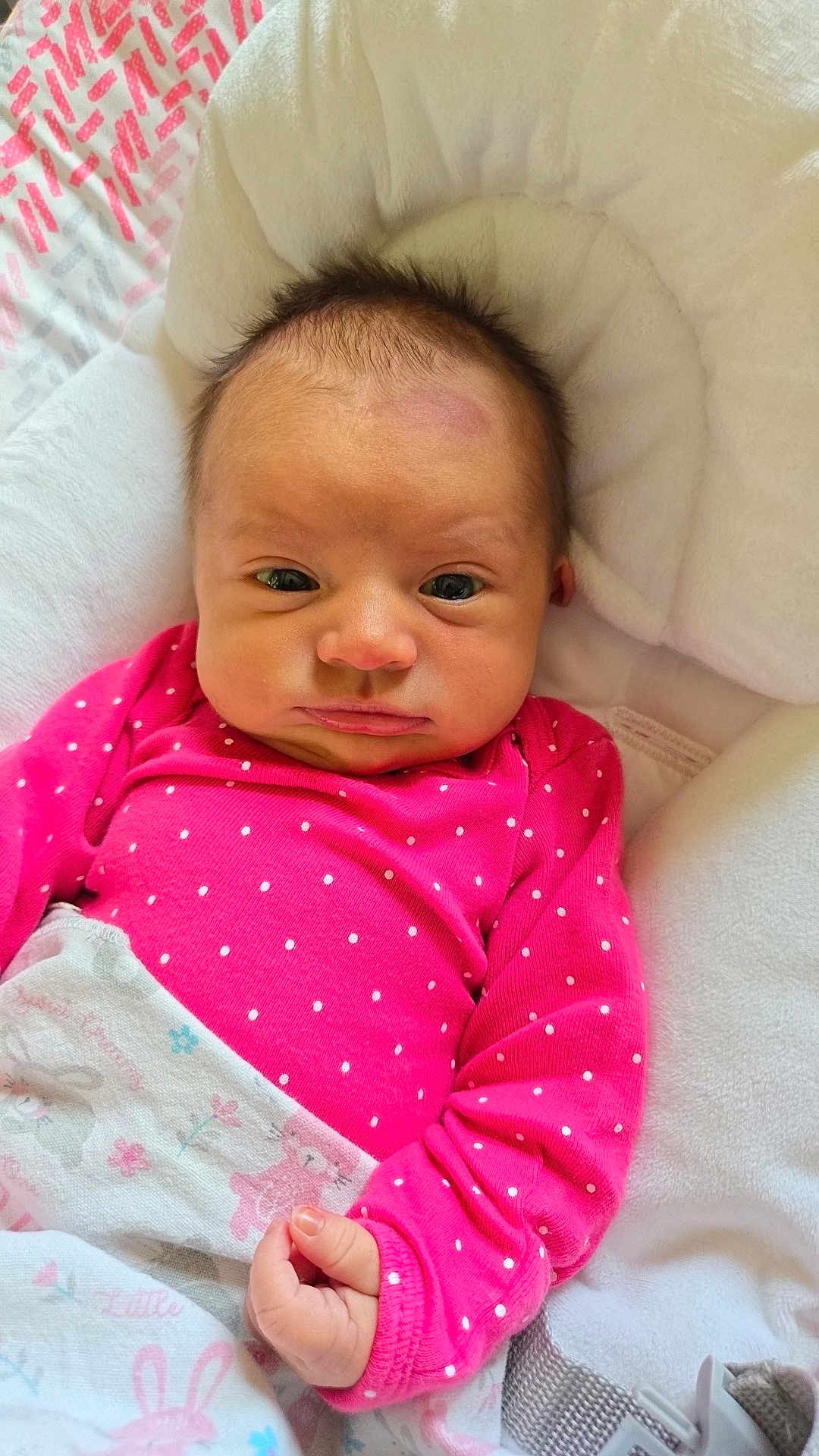 Everly Rose is registered to the contest to win money with this photo: baby, infant, child, pink_clothing, polka_dots, blanket, cushion, face, head, hand, indoor, portrait, newborn, sleepy, wrapped, cute, soft, resting, person, young