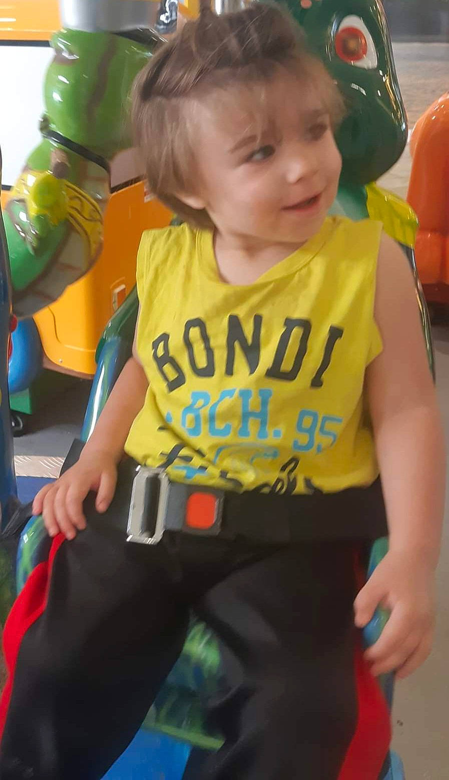 Artymus-zeke is registered to the contest to win money with this photo: baby_products, child, event, face, finger, fun, hair, happy, head, leisure, orange, person, personal_protective_equipment, recreation, sitting, sleeve, sportswear, t_shirt, thigh, toddler