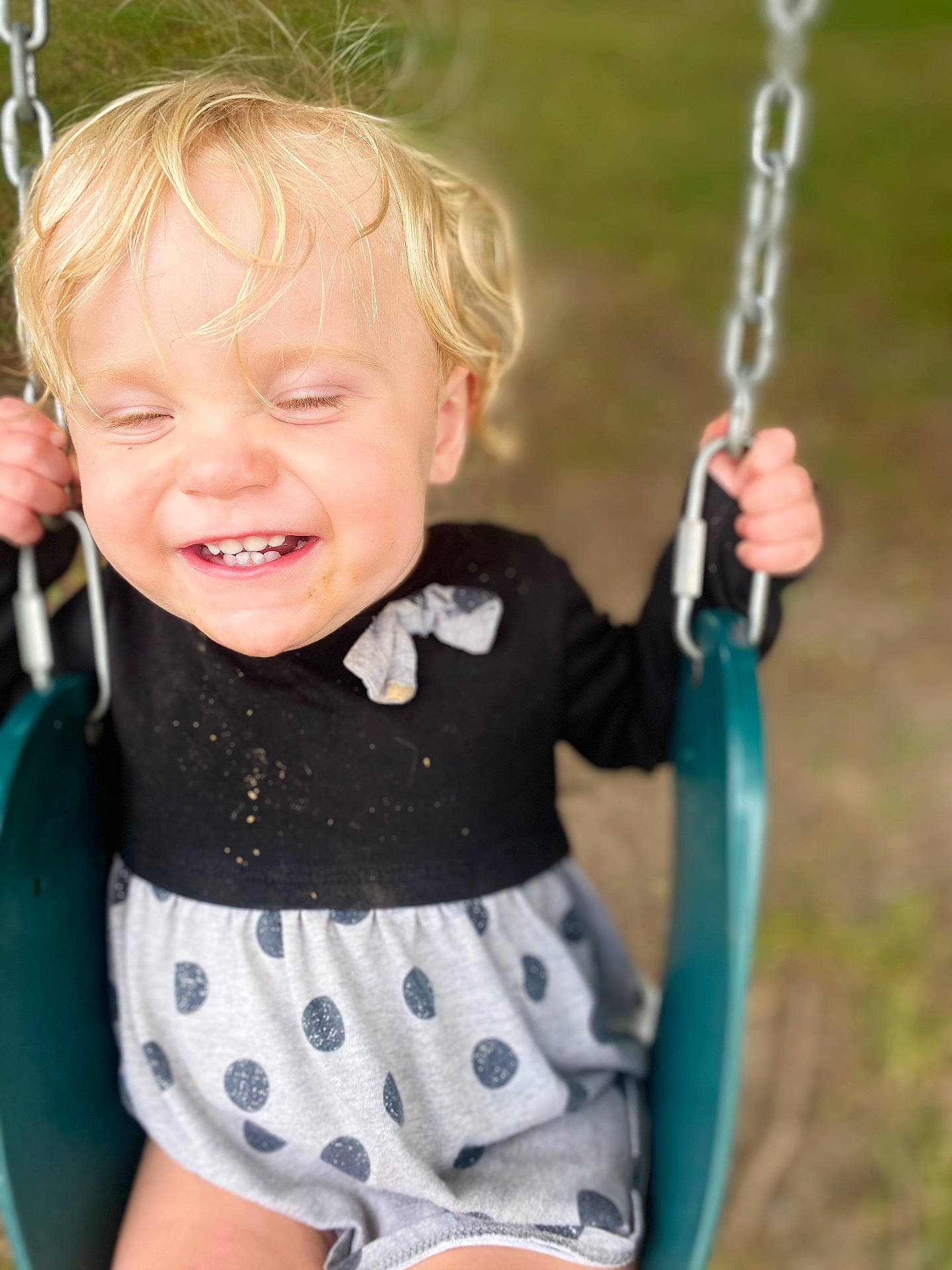 Ember is registered to the contest to win money with this photo: baby, blonde, clothing, face, grass, happy, head, nature, outdoorplayarea, outdoors, park, person, photography, plant, playarea, portrait, shorts, smile, swing, toy