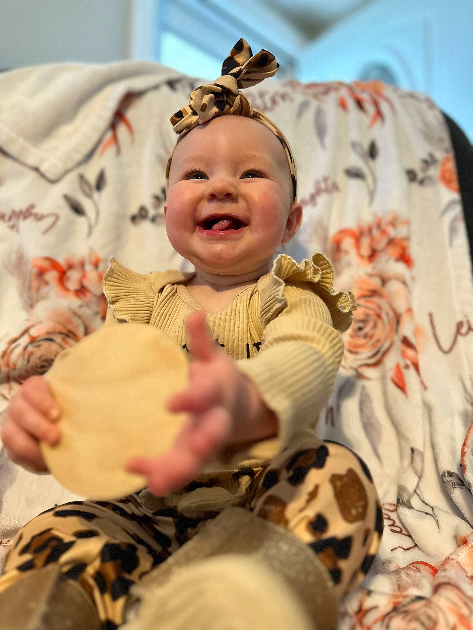 Leighton is registered to the contest to win money with this photo: abdomen, baby, baby_toddler_clothing, cheek, child, comfort, event, facial_expression, fun, fur, happy, hat, headwear, joy, pattern, peach, person, room, sitting, skin