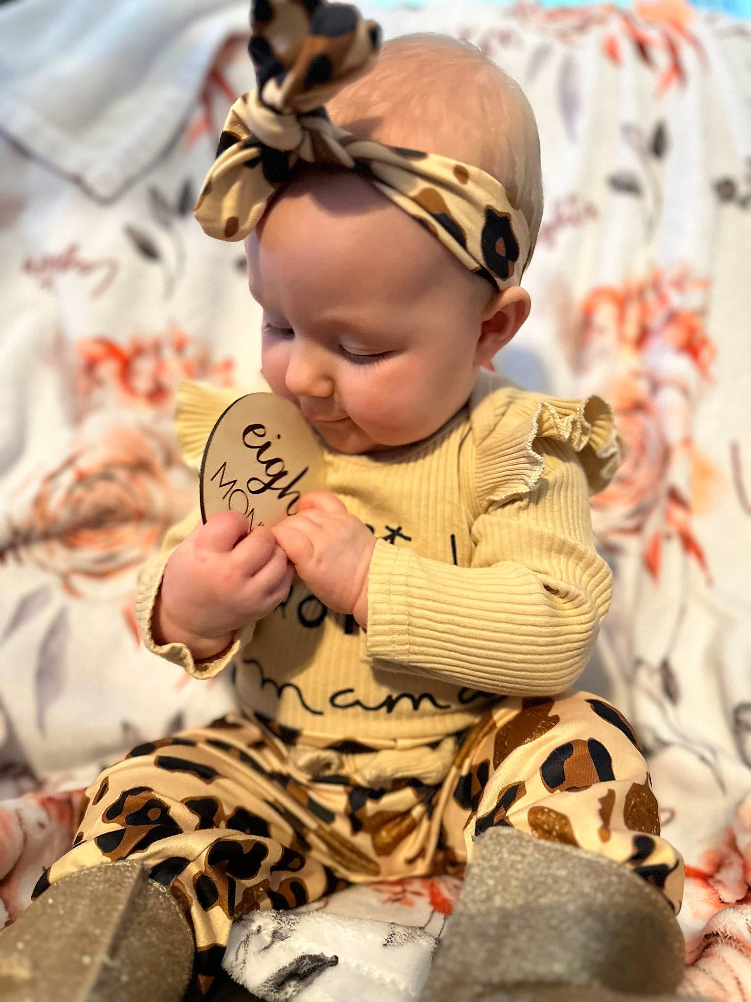 Leighton is registered to the contest to win money with this photo: baby, baby_toddler_clothing, child, doll, facial_expression, fashion_accessory, fawn, fun, fur, happy, hat, human, pattern, people, person, sitting, skin, textile, toddler, toy