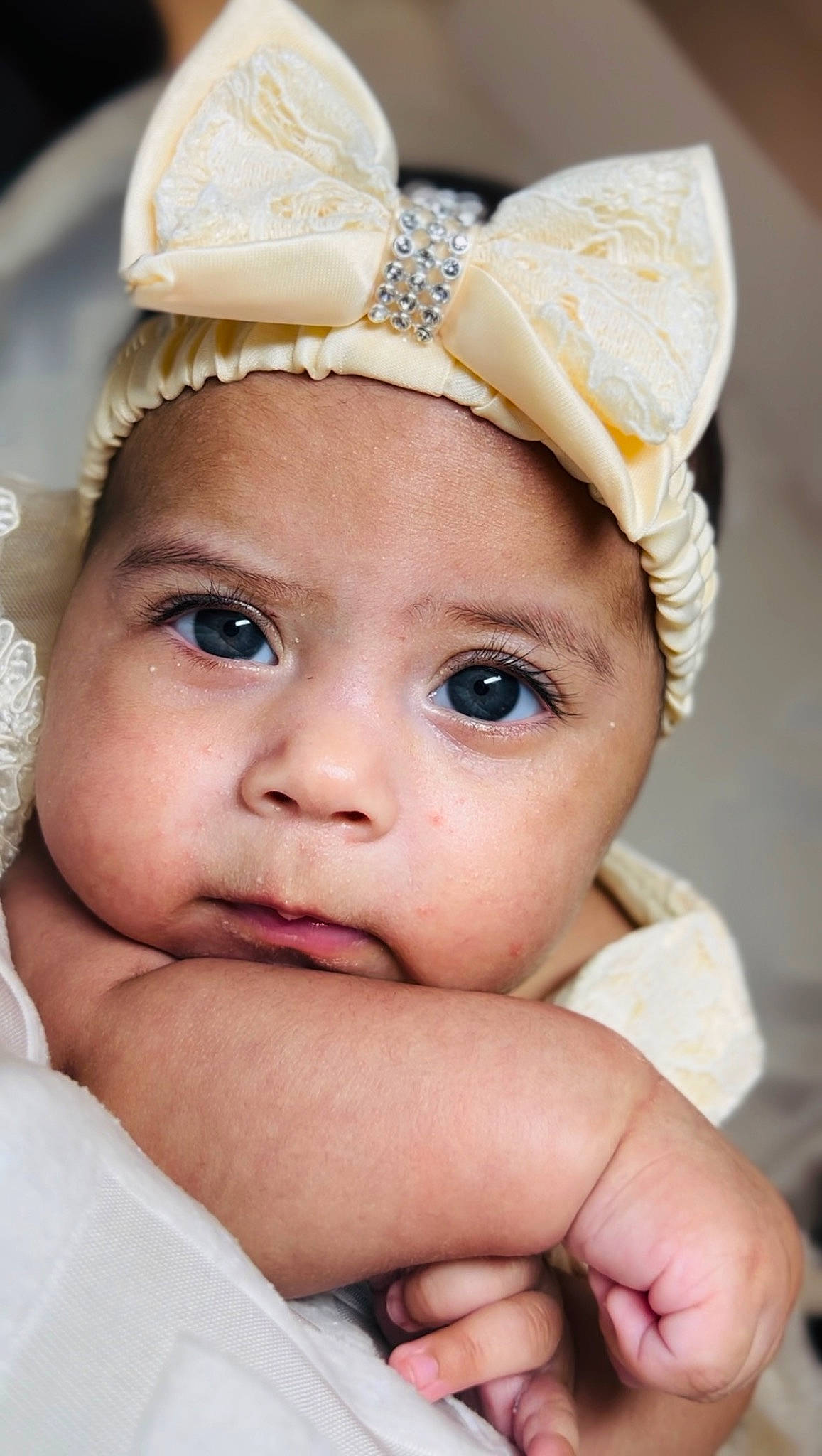 Camila is registered to the contest to win money with this photo: baby, cap, cheek, costume_hat, ear, eye, eyebrow, eyelash, finger, gesture, happy, headband, headgear, headpiece, headwear, iris, lip, nose, person, skin