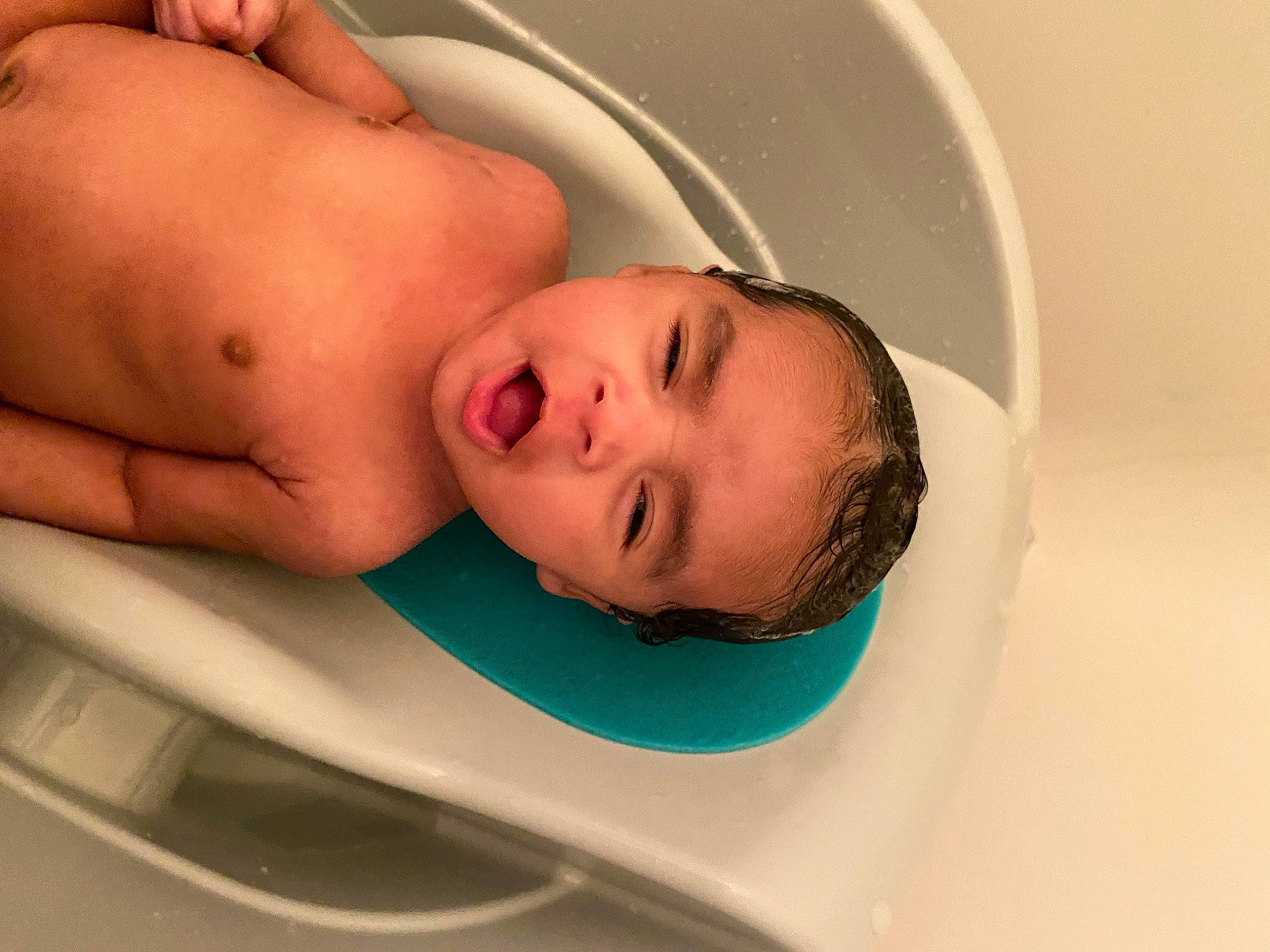 Diego is registered to the contest to win money with this photo: abdomen, baby, bathing, cheek, chest, child, comfort, ear, eye, eyebrow, eyelash, face, jaw, linens, lip, mouth, neck, nose, person, plumbing_fixture
